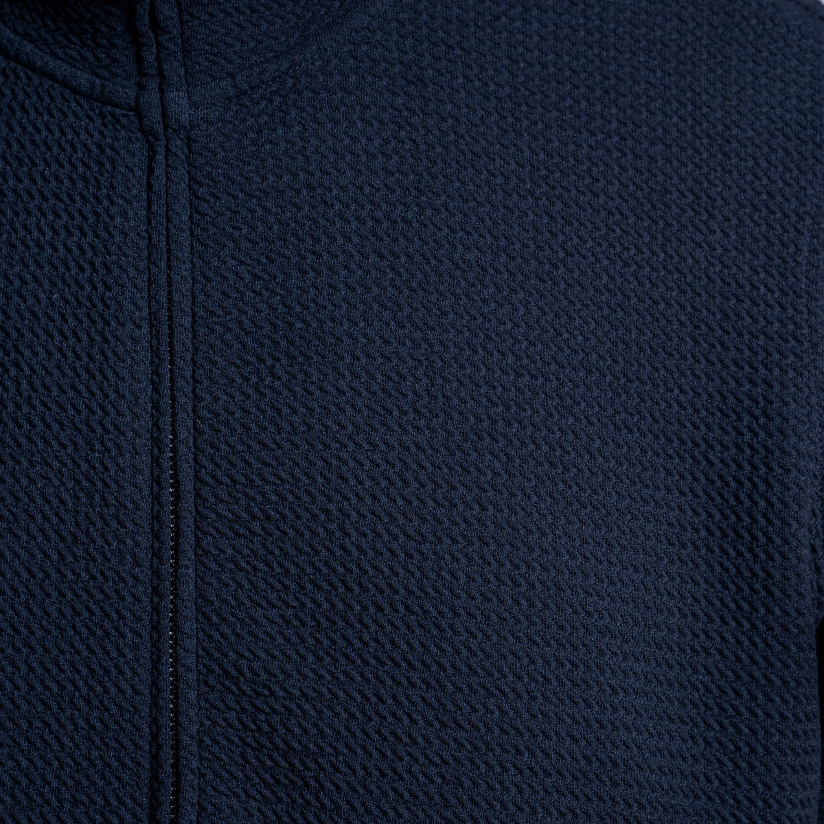Close-up of a dark navy blue textured zip-up garment, showing the fabric weave and zipper detail. Emporio Armani Sweatshirt. Sakks Menswear Southampton.