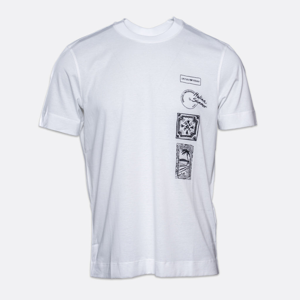 A white short-sleeve crewneck t-shirt with black graphic prints on the left chest, featuring a vertical stack of three rectangular designs and a circular logo print. Emporio Armani T-Shirt. Sakks Menswear Southampton.