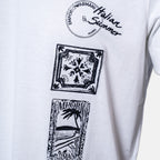 White short-sleeve T-shirt with black printed graphics: a circular 'Emporio Armani Italian Summer Milano' print at the chest, a square tile motif, and a beach scene print below. Emporio Armani T-Shirt. Sakks Menswear Southampton.