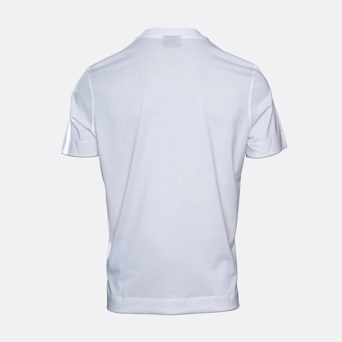 A white short-sleeve polo shirt shown from the back, photographed on a clean light gray studio background. Emporio Armani T-Shirt. Sakks Menswear Southampton.