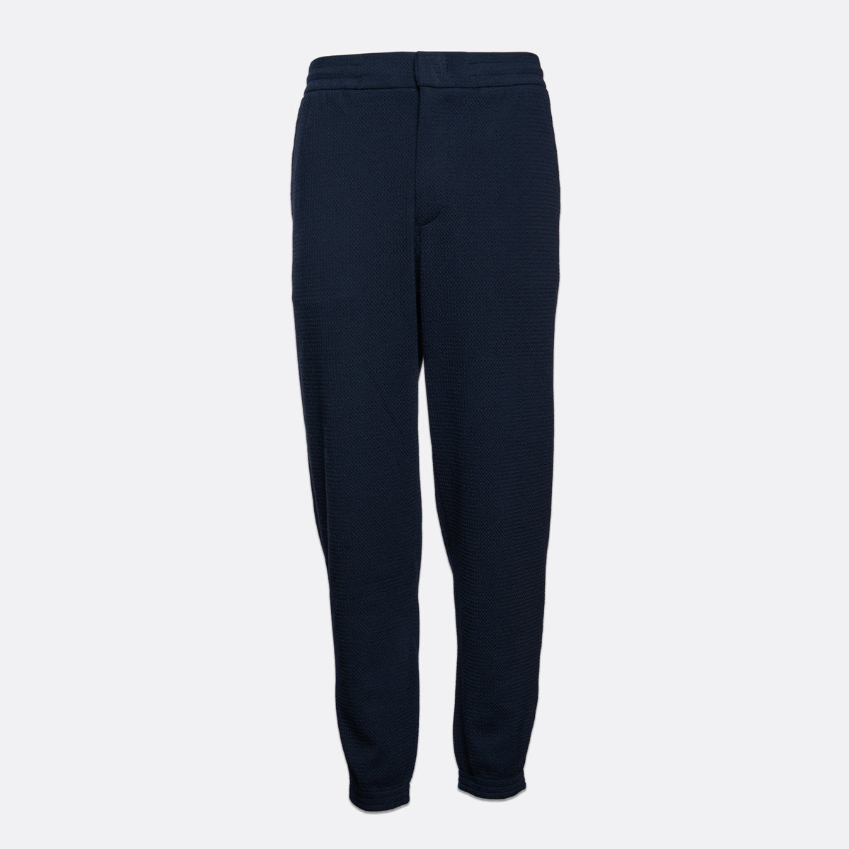 A pair of dark navy blue textured jogger pants shown flat against a light gray background. Emporio Armani Sweat Pants. Sakks Menswear Southampton.