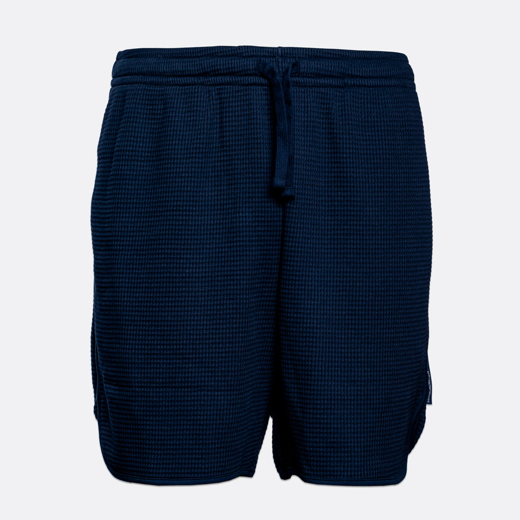 A pair of dark navy blue waffle-knit shorts with an elastic drawstring waistband, shown against a plain light gray background. Emporio Armani Shorts. Sakks Menswear Southampton.