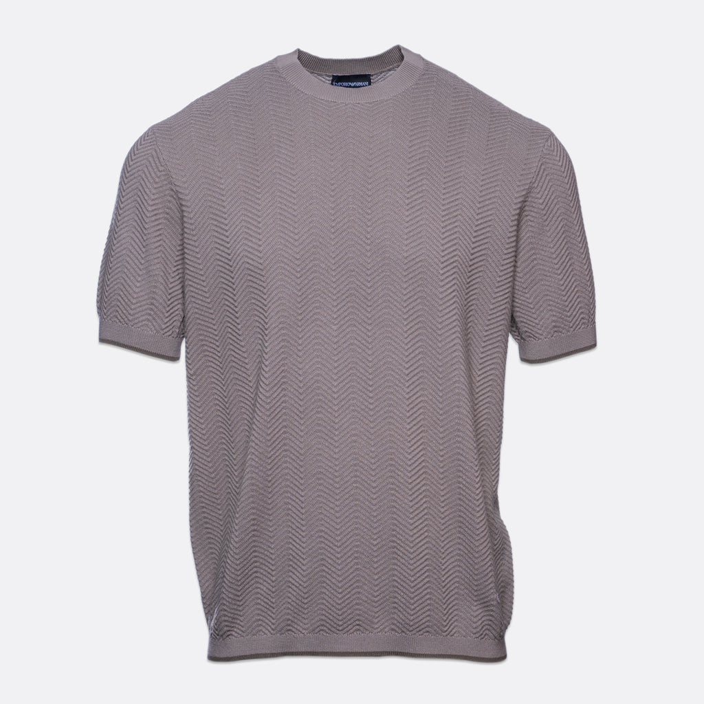 A short-sleeve crewneck knit t-shirt in a muted grayish-purple or taupe color, featuring a subtle wavy textured pattern, shown against a plain light gray background. Emporio Armani T-Shirt. Sakks Menswear Southampton.