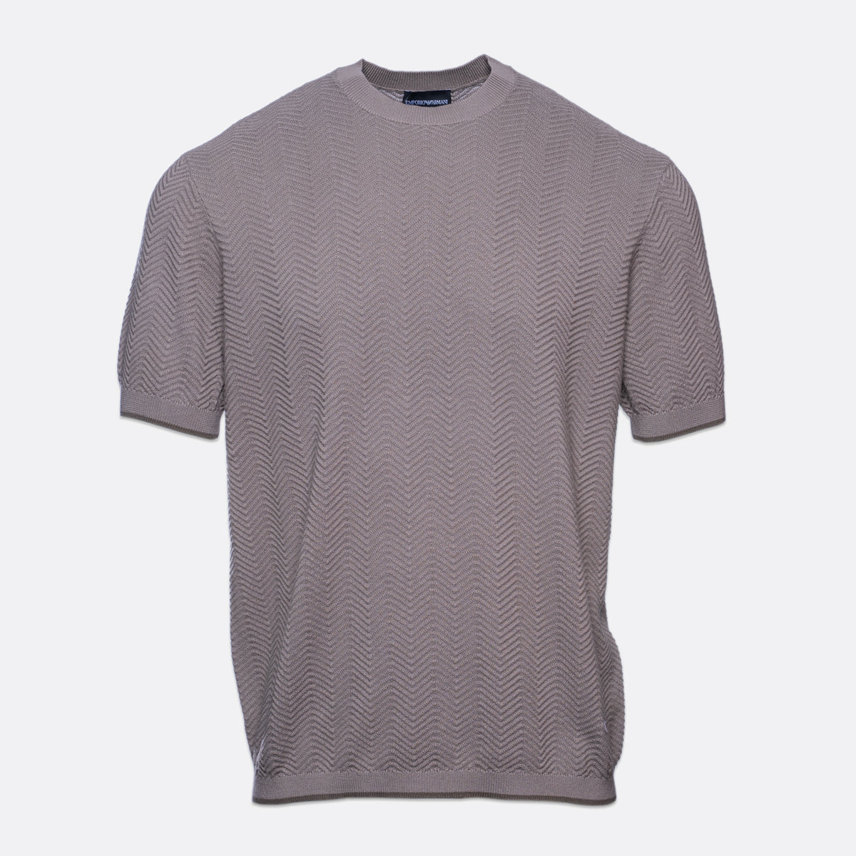 A short-sleeve crewneck knit t-shirt in a muted grayish-purple or taupe color, featuring a subtle wavy textured pattern, shown against a plain light gray background. Emporio Armani T-Shirt. Sakks Menswear Southampton.