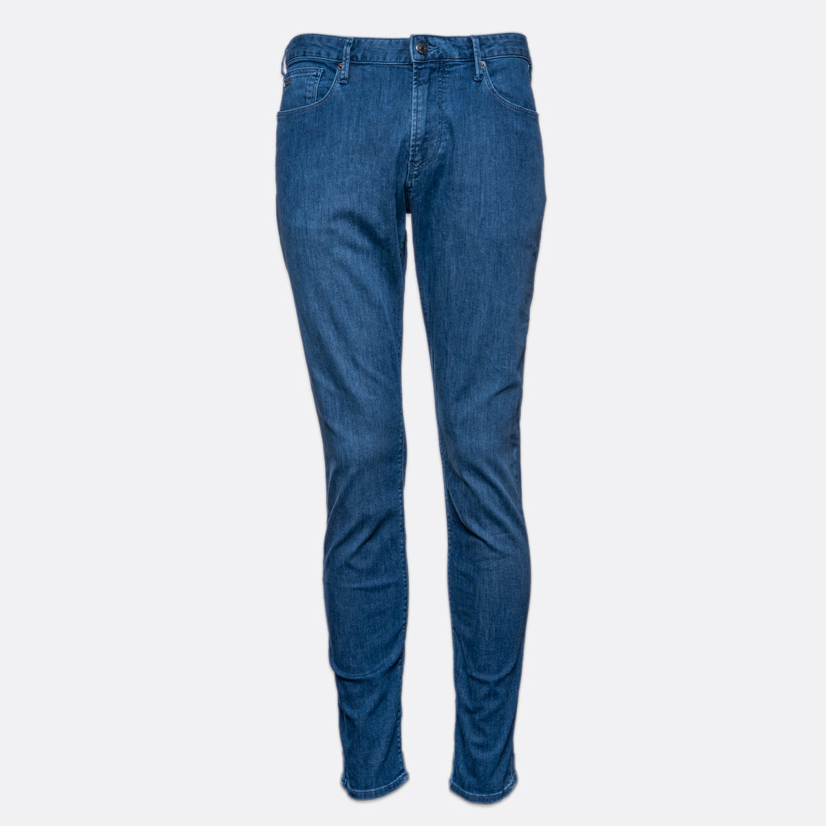A pair of slim-fit blue denim jeans shown flat against a light gray background. Emporio Armani Jeans. Sakks Menswear Southampton.
