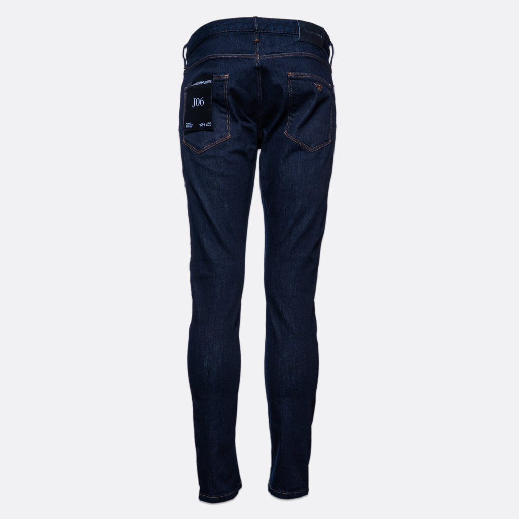 Dark blue slim-fit denim jeans shown on a light gray background. Emporio Armani Jeans. Sakks Menswear Southampton.