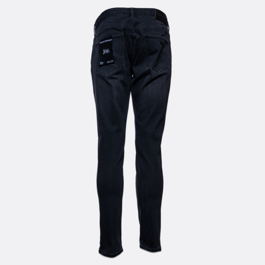 Back view of dark wash slim-fit jeans on a light gray background, showing the back pockets and a small white '306' patch on the right pocket. Emporio Armani Jeans. Sakks Menswear Southampton.