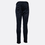 Back view of dark wash slim-fit jeans on a light gray background, showing the back pockets and a small white '306' patch on the right pocket. Emporio Armani Jeans. Sakks Menswear Southampton.