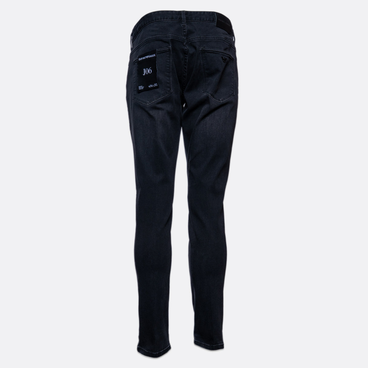 Back view of dark wash slim-fit jeans on a light gray background, showing the back pockets and a small white '306' patch on the right pocket. Emporio Armani Jeans. Sakks Menswear Southampton.