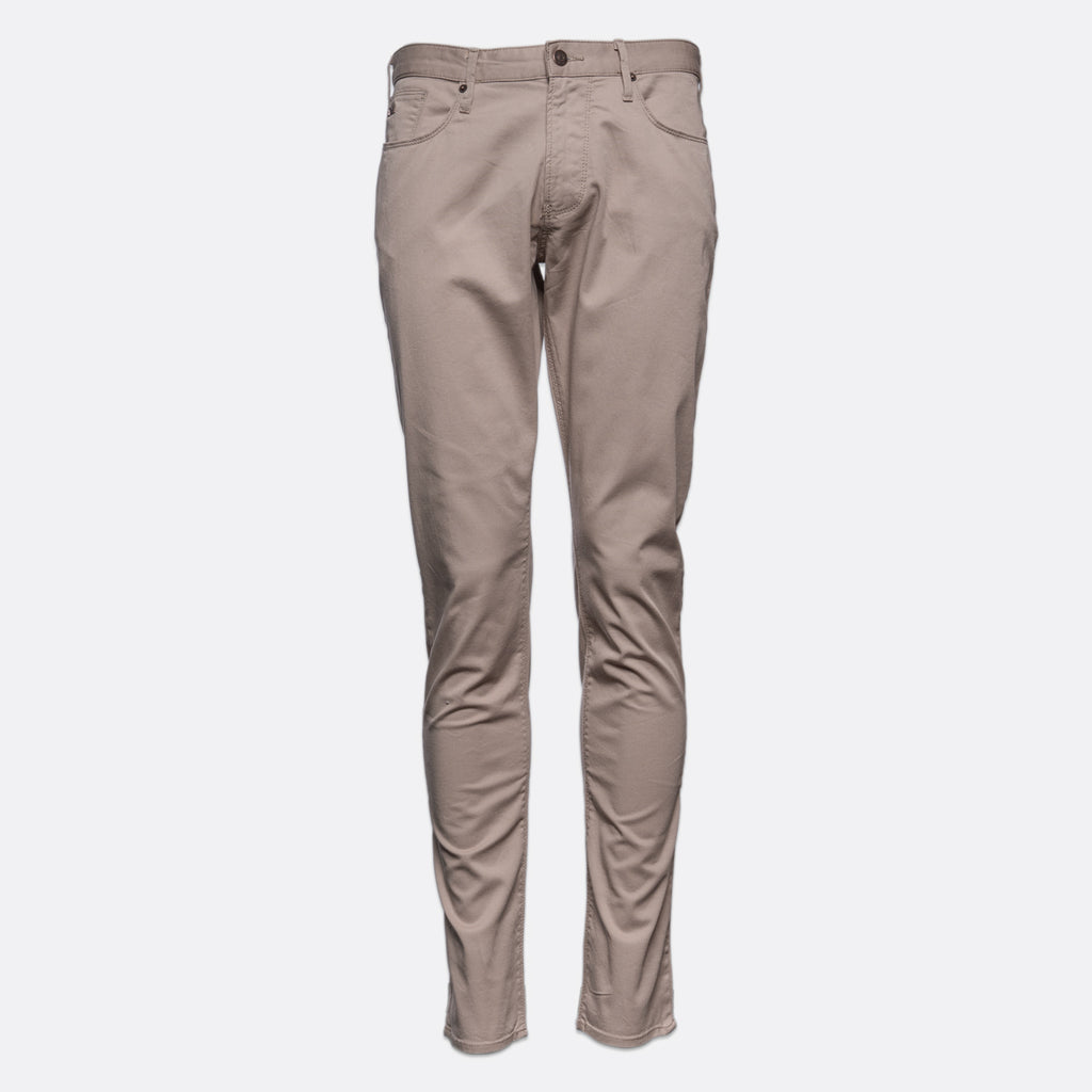 A pair of slim-fit, straight-leg jeans in a light taupe-beige color, shown on a plain light gray background. Emporio Armani Chinos. Sakks Menswear Southampton.