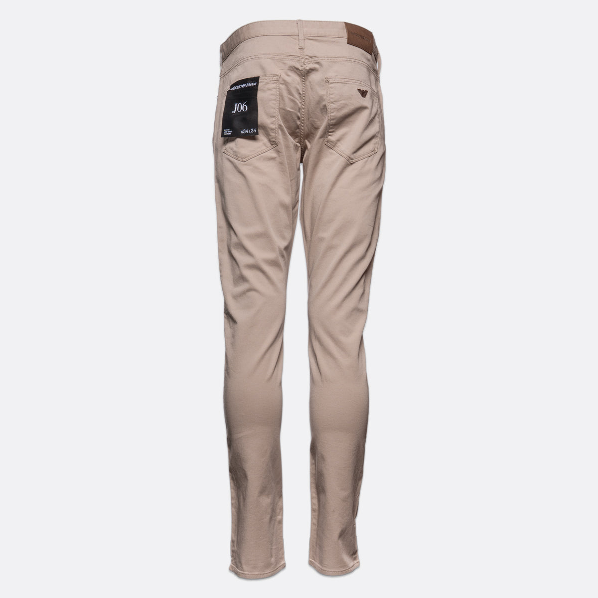A pair of slim-fit beige trousers shown from the back, featuring a brown leather waistband patch and a black brand label on the right pocket, set against a plain light gray background. Emporio Armani Chinos. Sakks Menswear Southampton.
