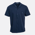 A navy blue short-sleeve button-up shirt with a camp collar, featuring a left chest pocket with a small embroidered logo and a subtle textured weave, shown on a light gray background. Emporio Armani Short Sleeve Shirt. Sakks Menswear Southampton.