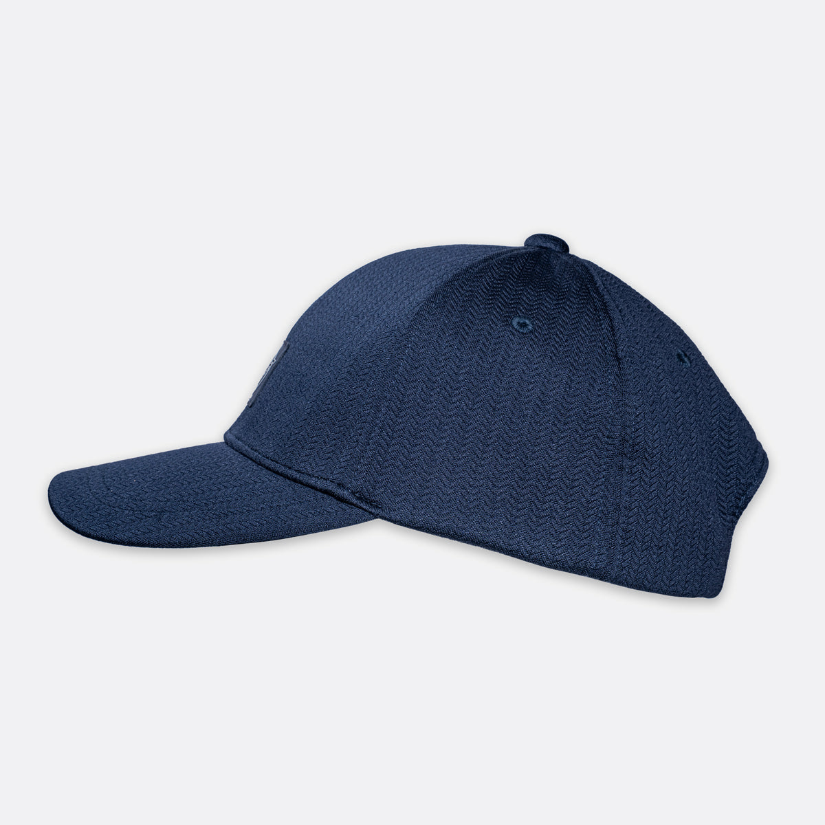 A dark navy blue baseball cap with a textured wavy pattern, shown from a side profile view against a light gray background. Emporio Armani Cap. Sakks Menswear Southampton