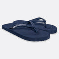 A pair of navy blue Armani Exchange flip-flops with the brand name printed in white on the strap, set against a light gray background. Emporio Armani Flip Flops. Sakks Menswear Southampton.