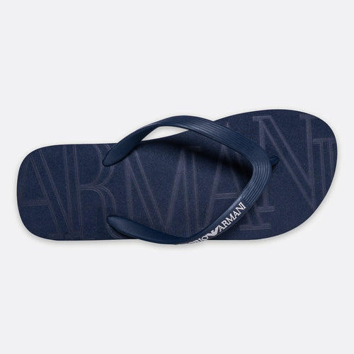 A single navy blue Armani Exchange flip-flop sandal shown from a top-down view on a light gray background. Emporio Armani Flip Flops. Sakks Menswear Southampton.
