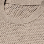 Close-up of a textured knit crewneck sweater in a warm taupe-beige color, showing the ribbed collar and waffle-knit fabric. Eton Knitwear available at Sakks Menswear in Southampton.