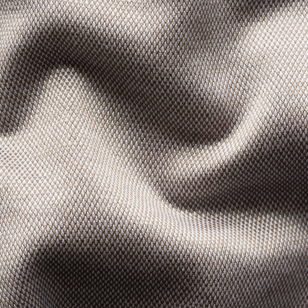 Close-up of a textured woven fabric with a fine mesh-like pattern, shown in soft folds with a colour gradient from light taupe to dark grey. Eton Shirt available at Sakks Menswear in Southampton.