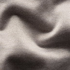 Close-up of a textured woven fabric with a fine mesh-like pattern, shown in soft folds with a colour gradient from light taupe to dark grey. Eton Shirt available at Sakks Menswear in Southampton.