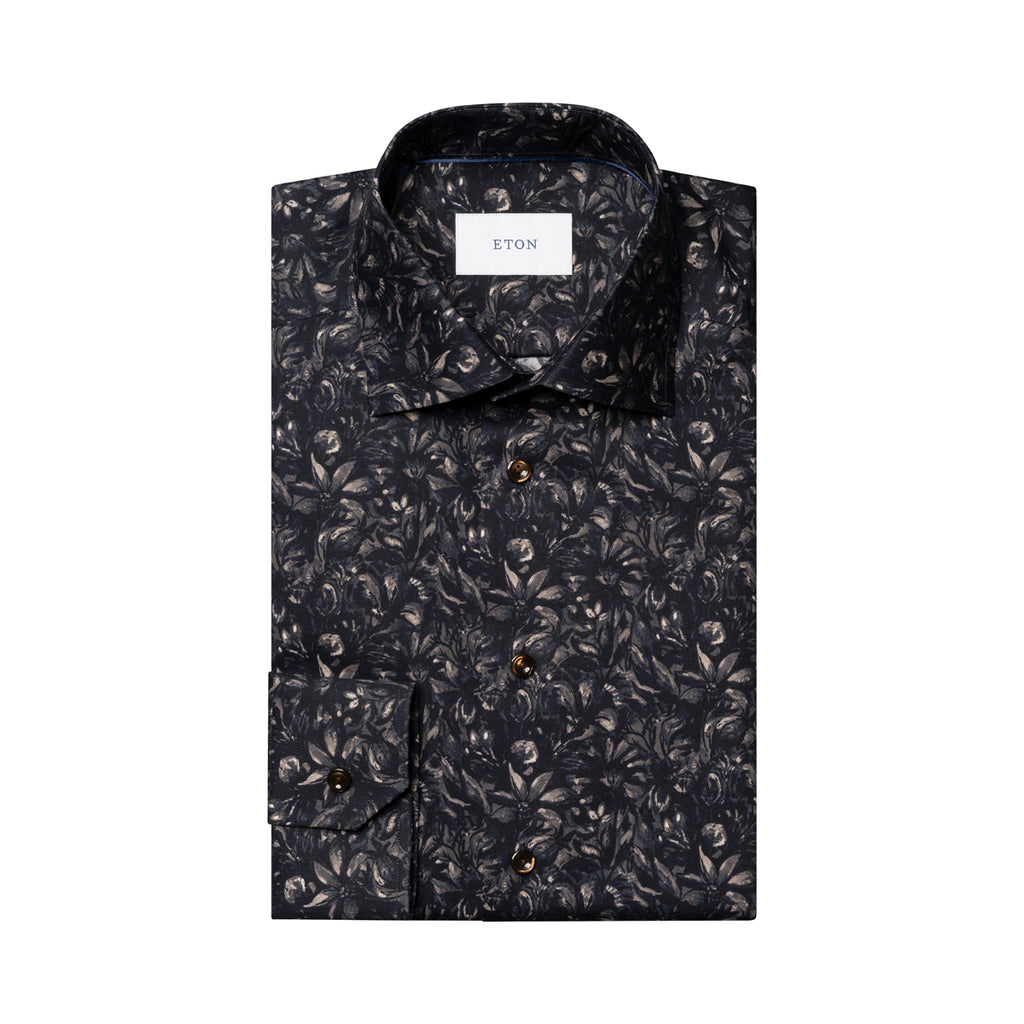 A folded long-sleeve button-up shirt by ETON, featuring an all-over dark floral and leaf pattern in black, gray, and brown tones, with a white neck label. Eton Shirt available at Sakks Menswear in Southampton.