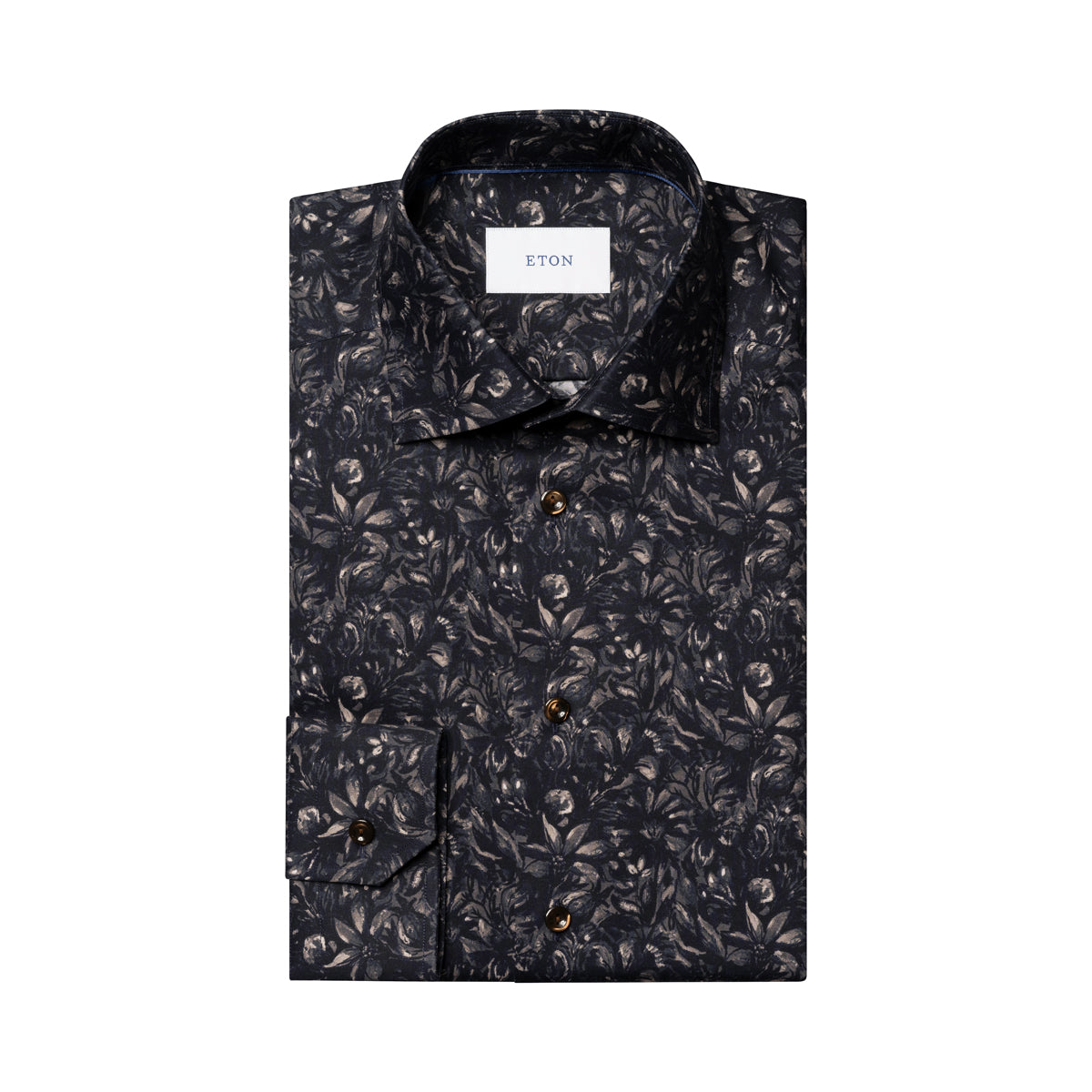 A folded long-sleeve button-up shirt by ETON, featuring an all-over dark floral and leaf pattern in black, gray, and brown tones, with a white neck label. Eton Shirt available at Sakks Menswear in Southampton.