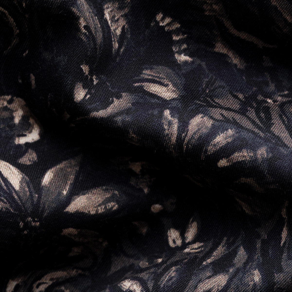 Black sheer lace fabric with a metallic gold floral and leaf pattern, shown in soft folds. Eton Shirt available at Sakks Menswear in Southampton.
