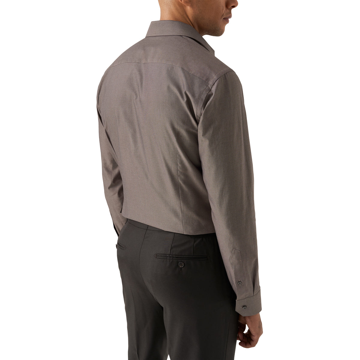A man shown from the back wearing a long-sleeve button-down shirt in a solid taupe-grey colour, paired with dark grey trousers, against a plain white background. Eton Shirt available at Sakks Menswear in Southampton.