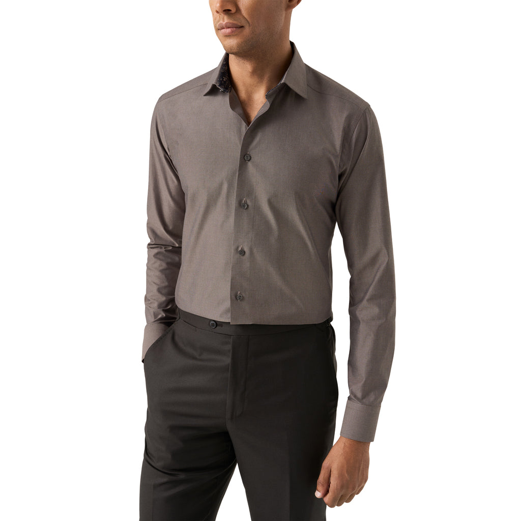 A man wearing a long-sleeve button-down dress shirt in a solid dark grey colour, paired with black trousers, shown from the chin down against a plain white background. Eton Shirt available at Sakks Menswear in Southampton.