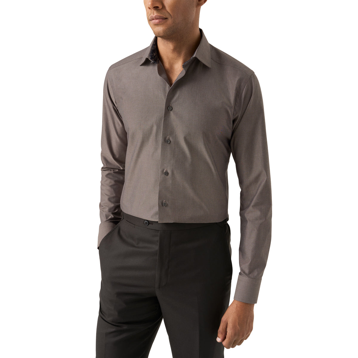 A man wearing a long-sleeve button-down dress shirt in a solid dark grey colour, paired with black trousers, shown from the chin down against a plain white background. Eton Shirt available at Sakks Menswear in Southampton.