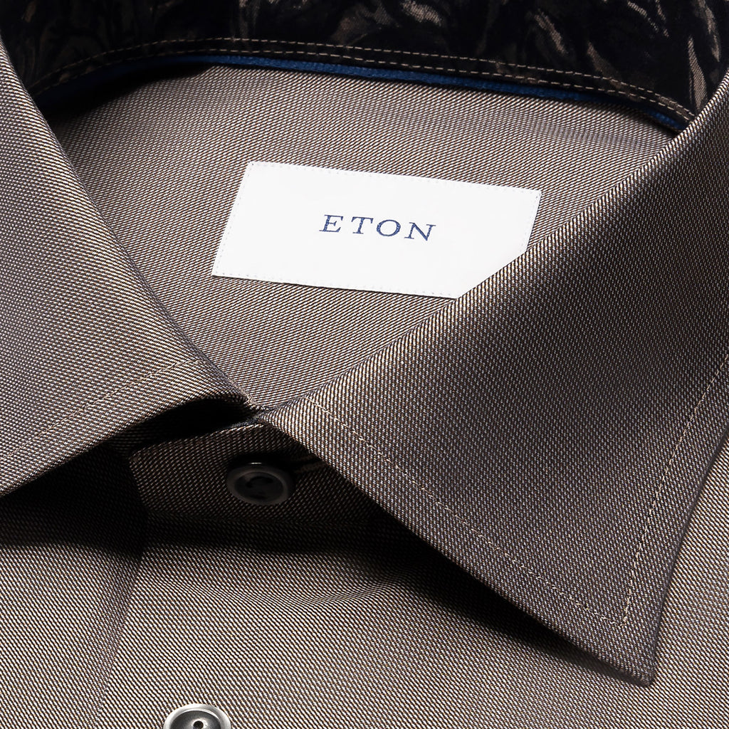 Close-up of a collared dress shirt in a taupe-grey colour, showing the inner neck label with the brand name ETON. Eton Shirt available at Sakks Menswear in Southampton.