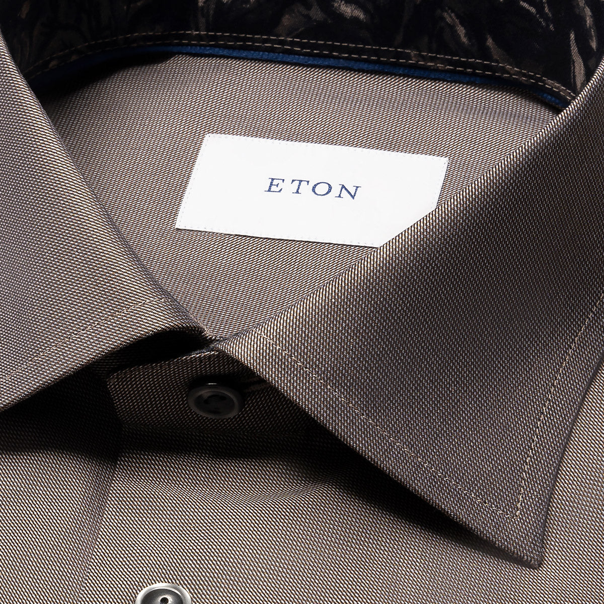 Close-up of a collared dress shirt in a taupe-grey colour, showing the inner neck label with the brand name ETON. Eton Shirt available at Sakks Menswear in Southampton.