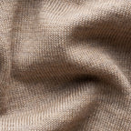 Close-up of a beige knit fabric texture with soft folds and ribbed stitching. Eton Cardigan available at Sakks Menswear in Southampton.