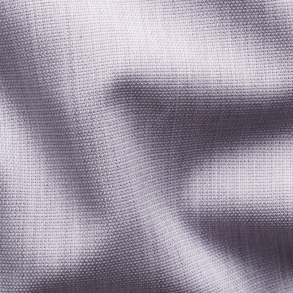 Close-up of a textured knit fabric in a light lavender-grey colour, showing the detailed weave and soft folds. Eton Shirt available at Sakks Menswear in Southampton.
