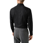 A man viewed from the back wearing a black long-sleeve dress shirt and gray trousers against a plain white background. Eton Shirt available at Sakks Menswear in Southampton.
