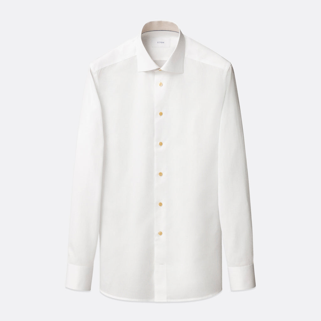 A white long-sleeve button-down dress shirt with a classic collar and light-coloured buttons, displayed on a clean, light grey background. Eton Shirt available at Sakks Menswear in Southampton.