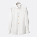 A white long-sleeve button-down dress shirt with a classic collar and light-coloured buttons, displayed on a clean, light grey background. Eton Shirt available at Sakks Menswear in Southampton.