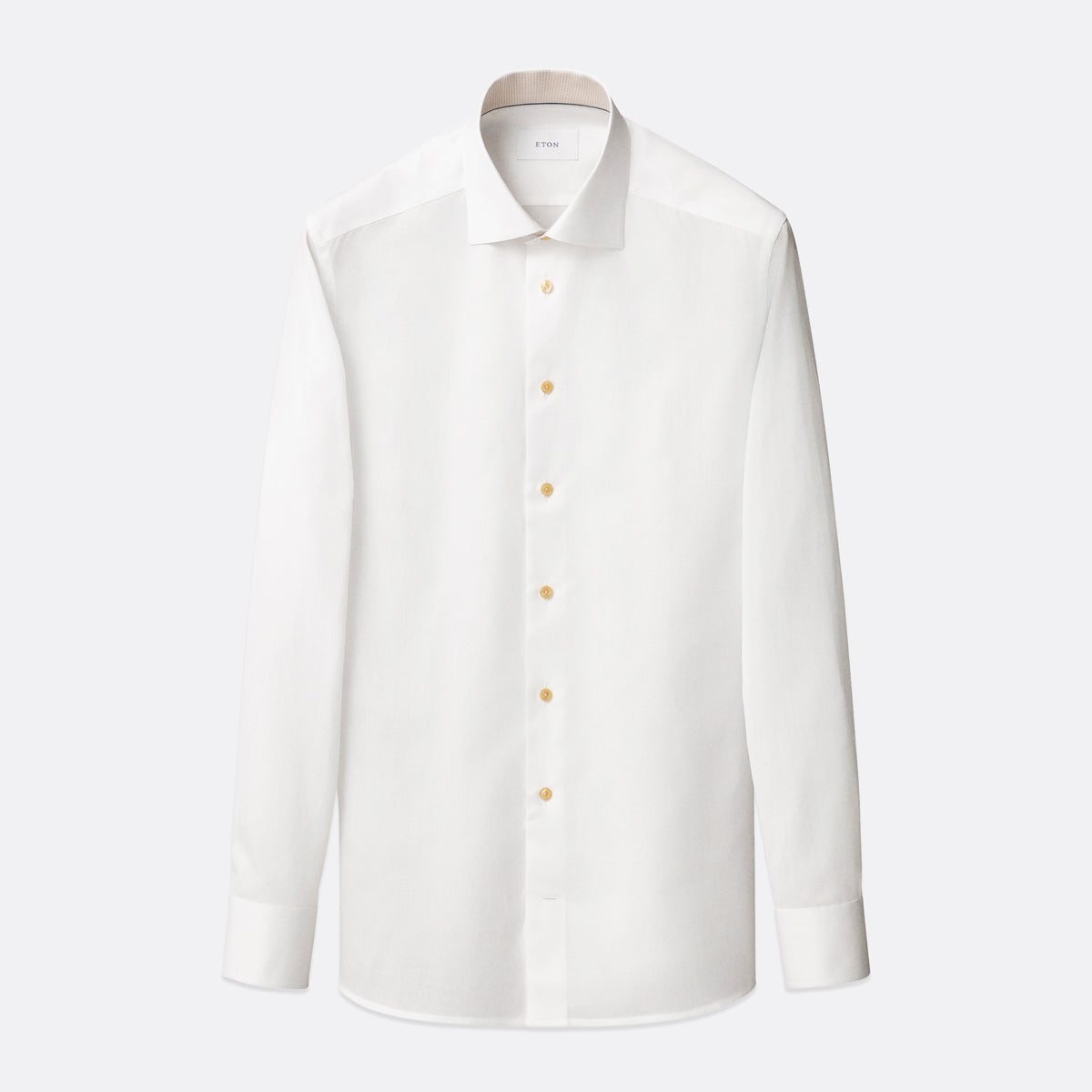 A white long-sleeve button-down dress shirt with a classic collar and light-coloured buttons, displayed on a clean, light grey background. Eton Shirt available at Sakks Menswear in Southampton.