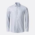 A light blue long-sleeve dress shirt with a classic collar and light-coloured buttons, shown on a clean light grey background. Eton Shirt available at Sakks Menswear in Southampton.