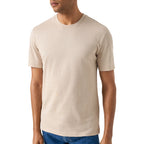 A man wearing a plain beige crew-neck short-sleeve t-shirt, shown from the chin down against a clean white background. Eton T-Shirt available at Sakks Menswear in Southampton.