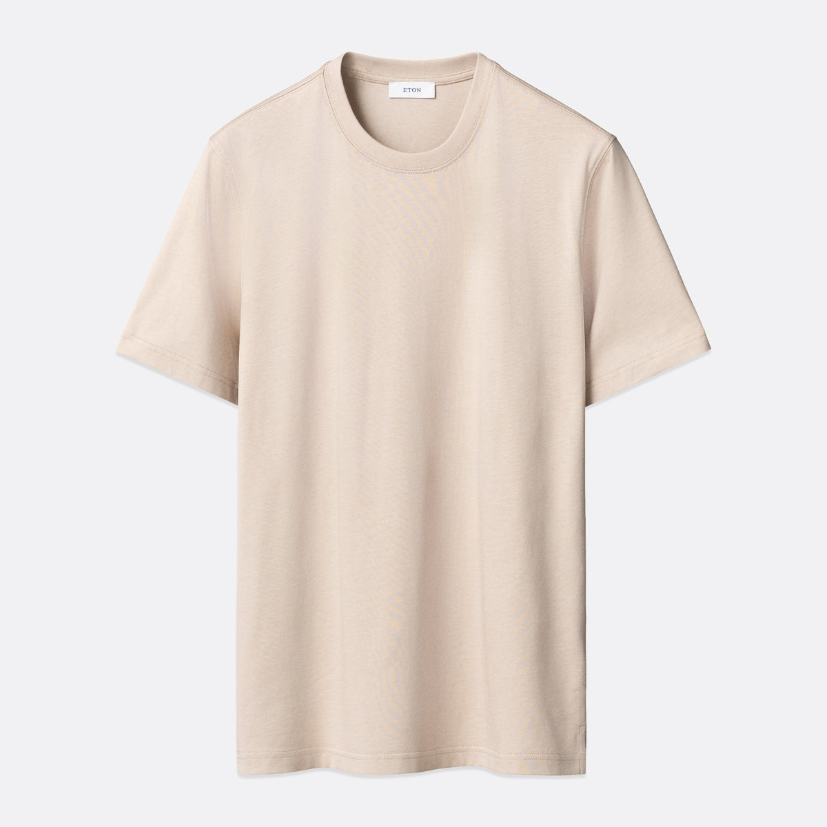 A light beige crewneck short-sleeve t-shirt displayed flat against a light grey background. Eton T-Shirt available at Sakks Menswear in Southampton.