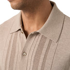 Close-up of a man wearing a beige ribbed knit polo shirt with vertical textured stripes and a buttoned collar. Eton Knitted Polo available at Sakks Menswear in Southampton.