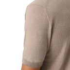 Close-up of a person wearing a short-sleeve knit top in a light taupe-beige color, showing the shoulder seam and ribbed sleeve cuff against a plain white background. Eton Knitted Polo available at Sakks Menswear in Southampton.