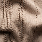 Close-up of a beige knit fabric with textured vertical ribbing and fine mesh-like knit patterns. Eton Knitted Polo available at Sakks Menswear in Southampton.