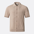 A beige short-sleeve knit polo shirt with vertical pleat details on the front, a button-down front, and a classic collar, shown against a light grey background. Eton Knitted Polo available at Sakks Menswear in Southampton.