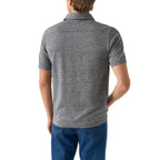 A man viewed from the back wearing a heather grey short-sleeve polo shirt and blue jeans, set against a plain white background. Eton Polo. Sakks Menswear Southampton.