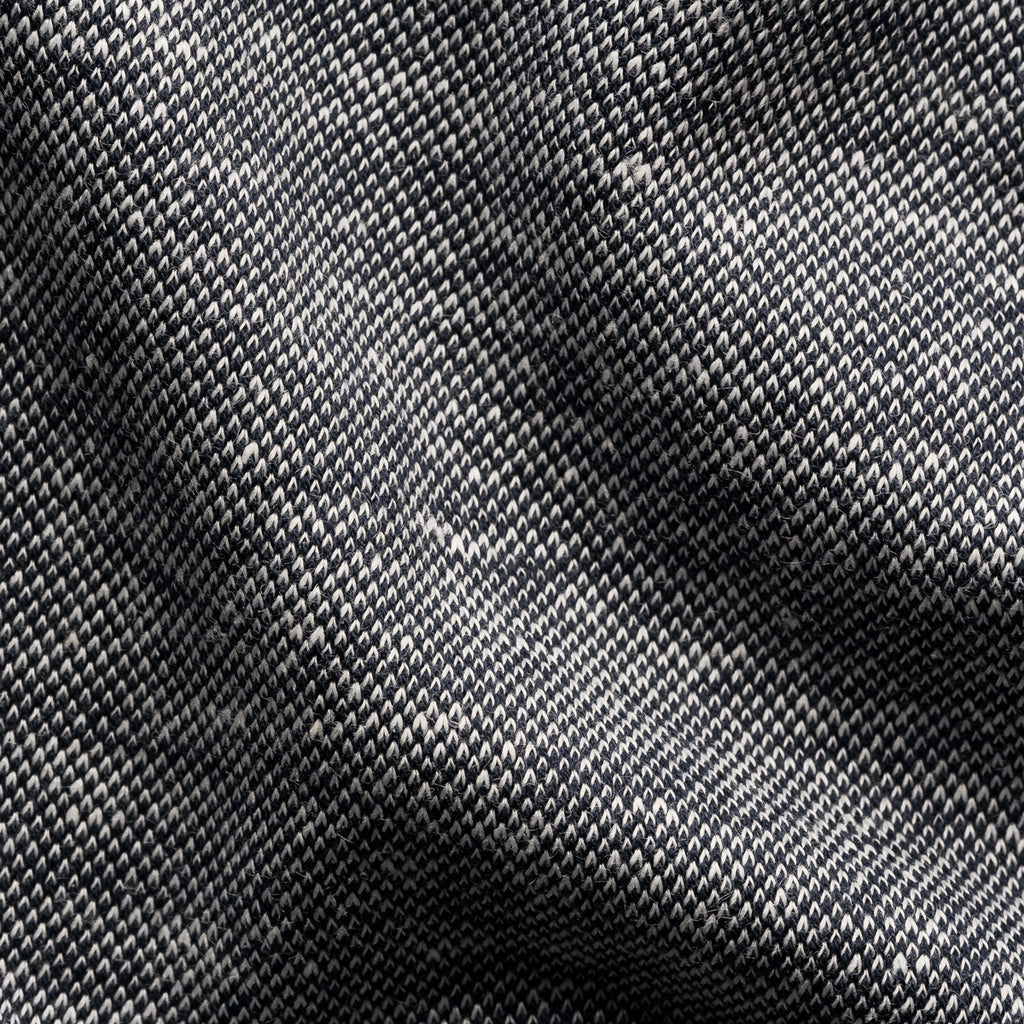 A close-up of a woven fabric texture with a dark grey and black diagonal twill pattern. Eton Polo. Sakks Menswear Southampton.
