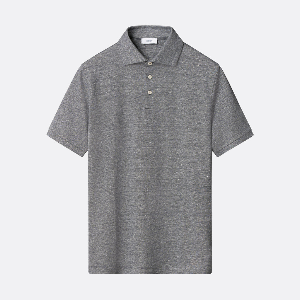 A short-sleeve polo shirt in heather grey, featuring a classic collar and a three-button placket, displayed against a light grey background. Eton Polo. Sakks Menswear Southampton.
