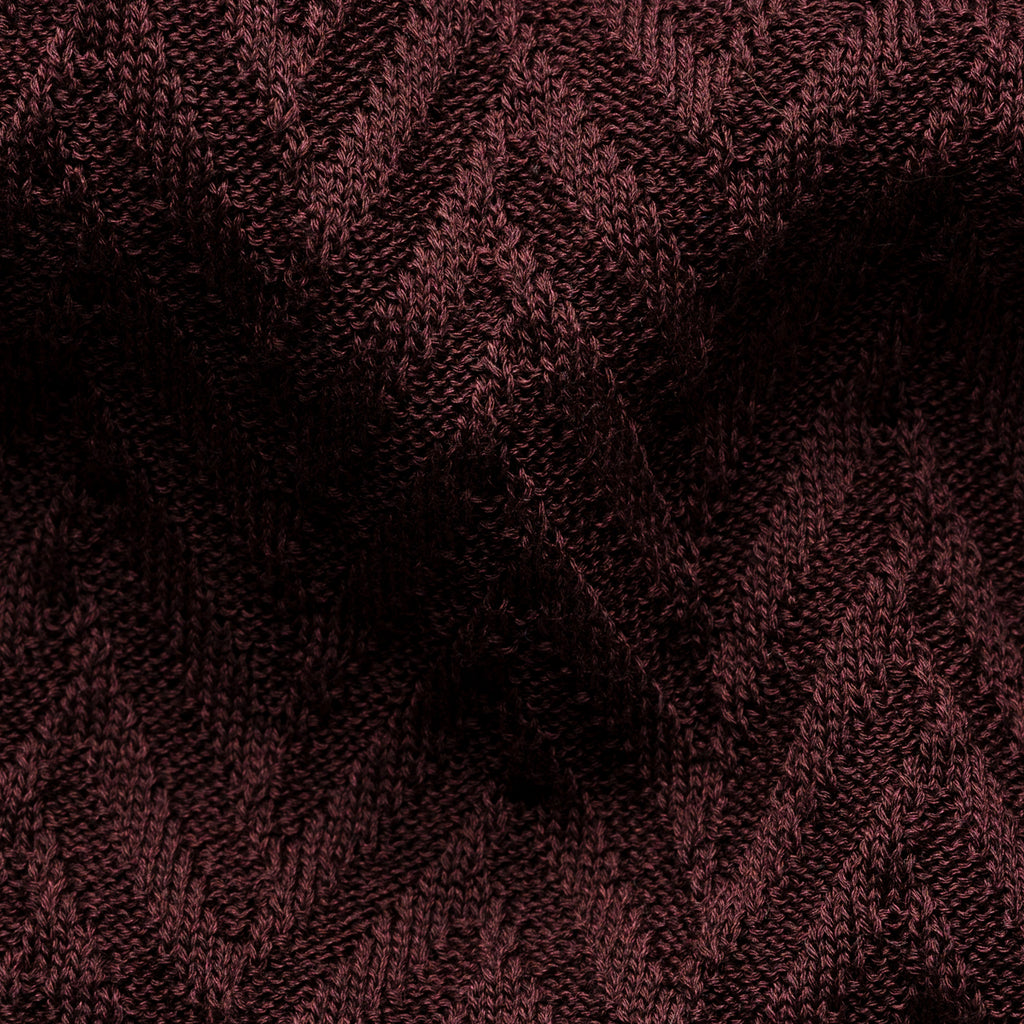 A close-up of a dark burgundy knit fabric with a textured chevron pattern. Eton Polo. Sakks Menswear Southampton.