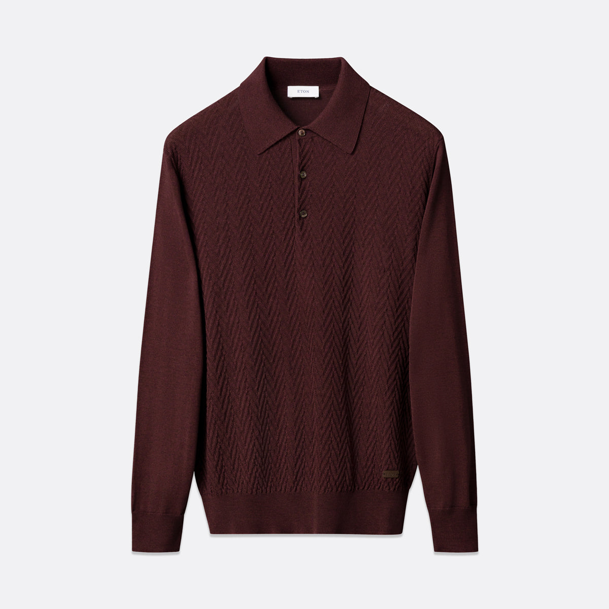 A dark burgundy knit polo sweater with a textured chevron pattern, displayed on a clean light gray background. Eton Polo. Sakks Menswear Southampton.