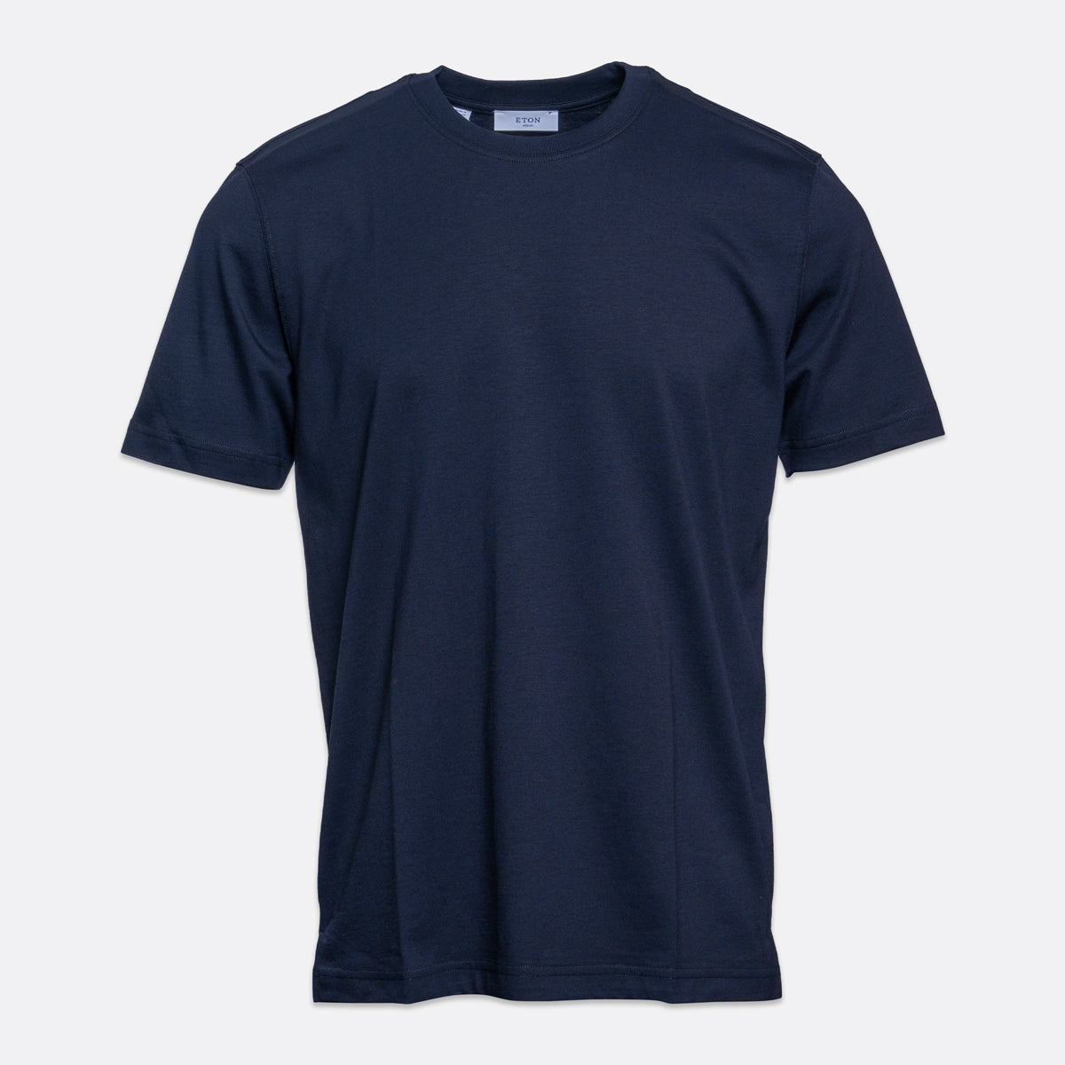 A classic short-sleeve crewneck t-shirt in dark navy blue, shown flat against a light gray background. Eton T-Shirt. Sakks Menswear Southampton.