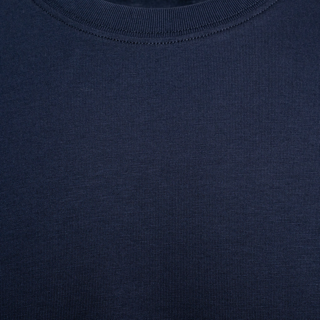 Close-up of a dark navy blue ribbed knit fabric, showing the texture and crew neck collar detail. Eton T-Shirt. Sakks Menswear Southampton.